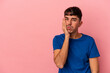 © Asier - Young mixed race man isolated on pink background who feels sad and pensive, looking at copy space.