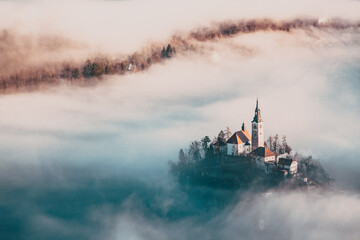 Wall Mural - amazing panorama of Lake Bled Blejsko Jezero on a foggy morning with the Pilgrimage Church of the Assumption of Maria on a small island and Bled Castle and Julian Alps in backgroud