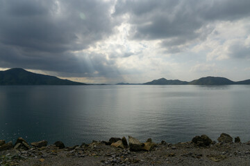 Canvas Print - View of the empty shore and the sea with the gloomy sky.