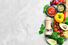 Food Background. Vegetables, Spices And Pepper Mill On A Gray Stone Background. Top View. Free Space For Text.