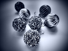 Christmas Background With Decorations And Holiday Striped Tinsel Balls. Happy New Year And Merry Christmas. Black And White Monochrome Modern Trendy Black White Decor On Gray Background Vignetting.