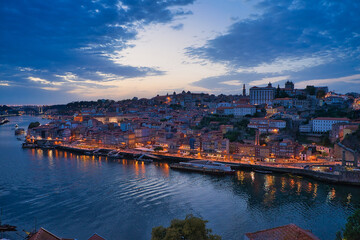 Poster - Cityscape of Porto, Portugal. The night city lights reflection on the water surface.