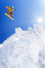 Wall Mural - Snowboarder jumping against blue sky in high mountains