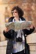 © Marc Calleja - Young tourist woman searching in the city with a map