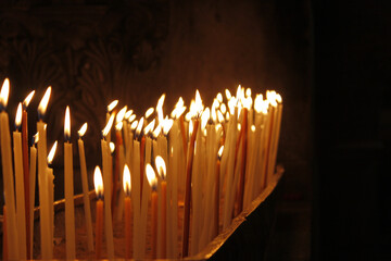 Poster - Closeup of lit candles in a church