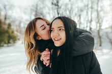 Close Up Photo Of Two Best Friends Hugging And Kissing In A Snowy Park, They Are Very Happy To Meet.