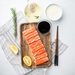 Wall Mural - Fresh Crab meat stick surimi with blue swimming crab, on wooden tray, on white background, top view flat lay