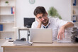 © Elnur - Young male employee unhappy with excessive work in the office