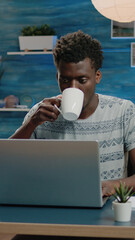 Poster - Freelance employee working from home on laptop and typing. Man doing remote corporate business work with technology while drinking cup of coffee. Networking entrepreneur with notebook