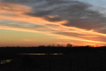 Poster - Sunset Over a Farm Field with a Lake