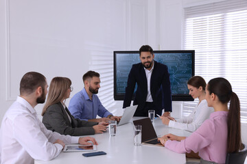 Sticker - Business trainer near interactive board in meeting room during presentation