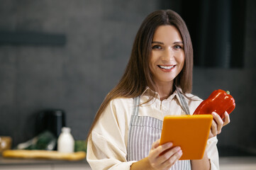 Poster - Long-haired young woman thinking about cooking something for lunch