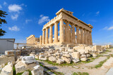 View of the Parthenon on Acropolis Hill in Athens, Greece with a deep blue sky behind.