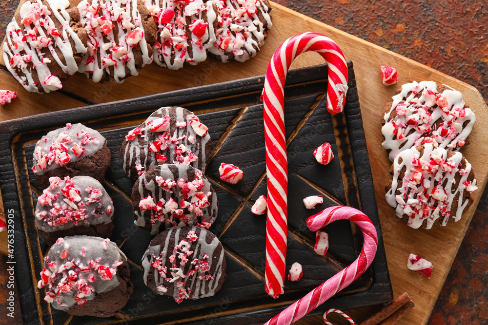 Wooden boards with tasty candy cane cookies on table
