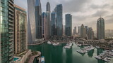 Fototapeta  - Dubai marina tallest skyscrapers and yachts in harbor aerial timelapse.