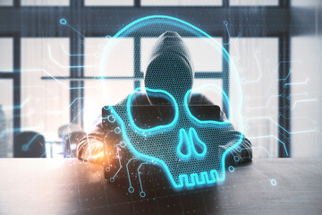 Aufkleber - Abstract image of hacker at desktop using laptop wwith glowing digital skull on blurry background. Hacker, technology and virus concept. Double exposure.
