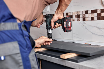 Sticker - Handyman making kitchen wall cabinets in the apartment.