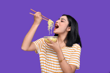 foodie girl eating noodle over purple background indian pakistani model 