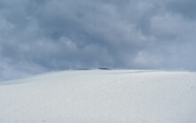 Selective Focus. Snowy Haze, Poor Visibility. Snow Mountain Dome. Big Snowy Mountain Under Gday Dramatic Cloud.