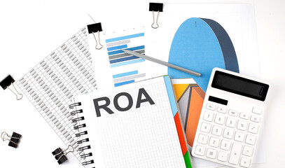 Poster - Text ROA on a notebook on the diagram and charts with calculator and pen