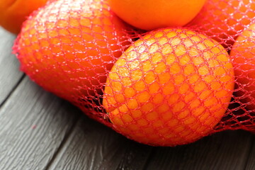many fresh oranges in a red net 