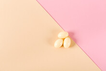 Three Tablets Over Pink And Beige Background. Vaginal Antibacterial Capsules. Close-up. Blister Pack Was Started. Copy Space. Medical Treatment. Flat Lay. Mockup Design. Nobody. Template. Medicine