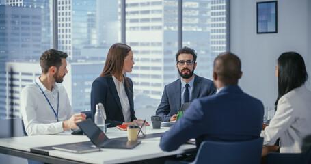 Wall Mural - Modern Multi-Ethnic Office Conference Room Meeting: Diverse Team of Young Top Managers, Executives Talk, Brainstorm, Use Tablet. Smiling Businesspeople Discuss Investment Strategy in ecommerce Startup