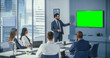 © Gorodenkoff - Diverse Office Conference Room Meeting: Male Project Manager Uses Green Screen Chroma Key Wall TV Presenting Opportunity for Group of Investors. e-Commerce Product Strategy. Medium Wide Shot