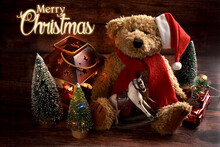Christmas Card With Vintage Style Teddy Bear In Santa Cap With Rocking Horse On Wooden Background