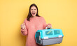 © kues1 - pretty woman shouting aggressively with an angry expression. pet carrier concept