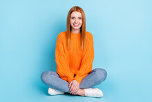 Full Length Photo Of Sweet Red Hairdo Young Lady Sit Wear Sweater Jeans Isolated On Blue Color Background
