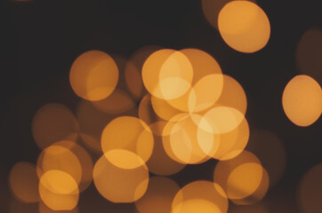 Wall Mural - golden defocused lights on a black background