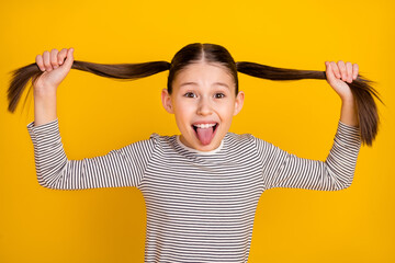 Sticker - Photo of young attractive girl happy positive smile fooling grimace tongue-out isolated over yellow color background