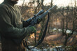 Professional hunter with hunting rifle. Man on the hunt in the middle of forest. Modern hunting rifle. 