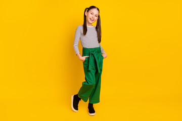 Sticker - Full body photo of young attractive school girl happy positive smile confident hands in pocket isolated over yellow color background