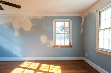 Empty Residencial Bedroom in the Middle of Renovation with Walls that Need to be Painted