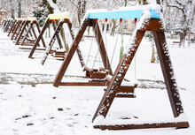 Snowy Municipal Playground In A City Park In Winter With No Children