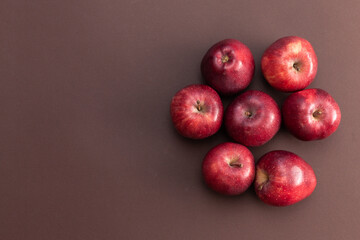 red apples isolated on brown background