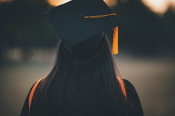 Wall Mural - Graduates wear a black dress, black hat at the university level.