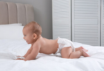 Canvas Print - Cute baby in dry soft diaper on white bed at home