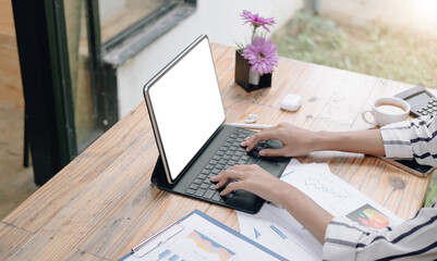 Wall Mural - Businesswoman using laptop blank screen while working with calculator for financial. Clipping path