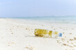 Single-Use Empty plastic bottle washed up on  the tropical beach