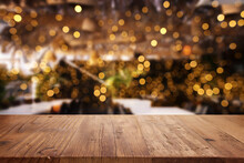 Title: Background Image Of Wooden Table In Front Of Abstract Blurred Restaurant Lights
