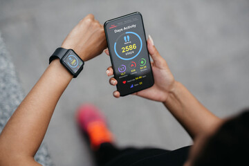 Poster - African american lady checking smartphone and smartwatch