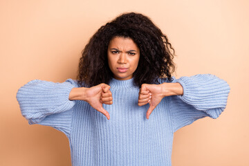 Sticker - Photo of young woman negative show thumb-down displeased ad rejection isolated over beige color background