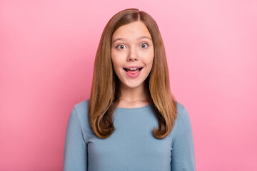 Wall Mural - Portrait of attractive amazed cheerful brown-haired girl good news reaction isolated over pink pastel color background