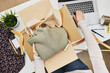 © Przemek Klos - Business owner packing online order to delivery to customer. Preparing parcel box with clothes product from online shop