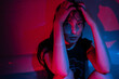 © DimaBerlin - Portrait in red neon light of young depressed asian woman suffering from alcohol or drug addiction, sitting in dark bathroom at home, having substance abuse problem. Depression and mental health