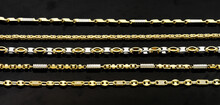 Gold Jewellery. Gold Chains On Black Background