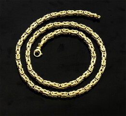 Wall Mural - Gold jewellery. Gold chains on black background